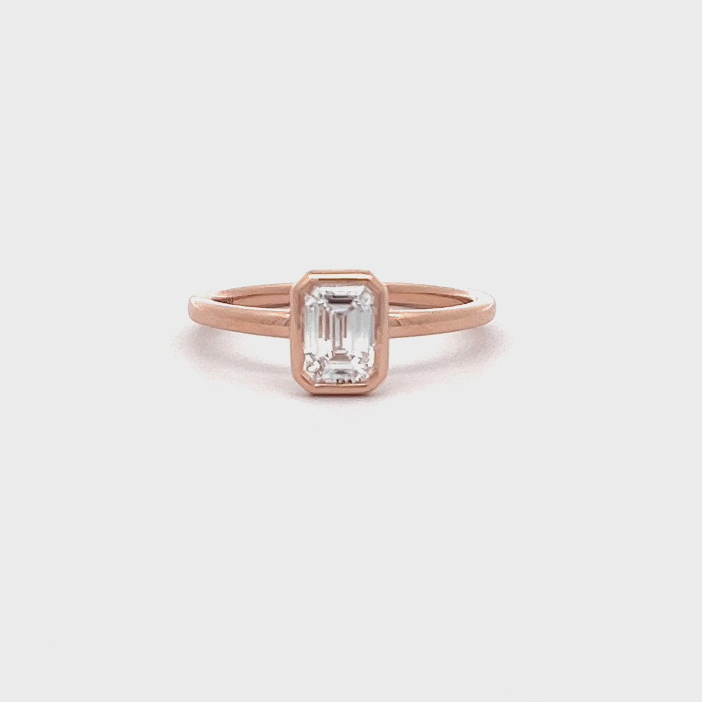 14k Rose Gold Bezel Set Emerald Cut Lab Grown Diamond Solitaire Engagement Ring (0.73ct.)