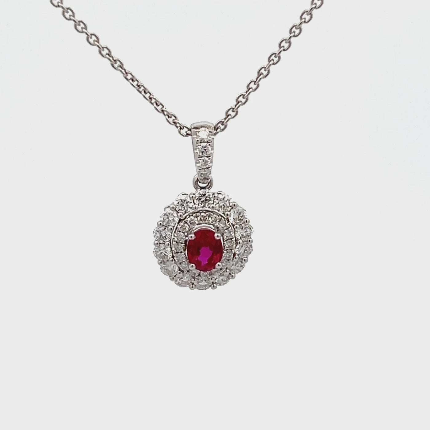18k White Gold Oval Ruby and Round Diamond Halo Pendant (0.38ct.)