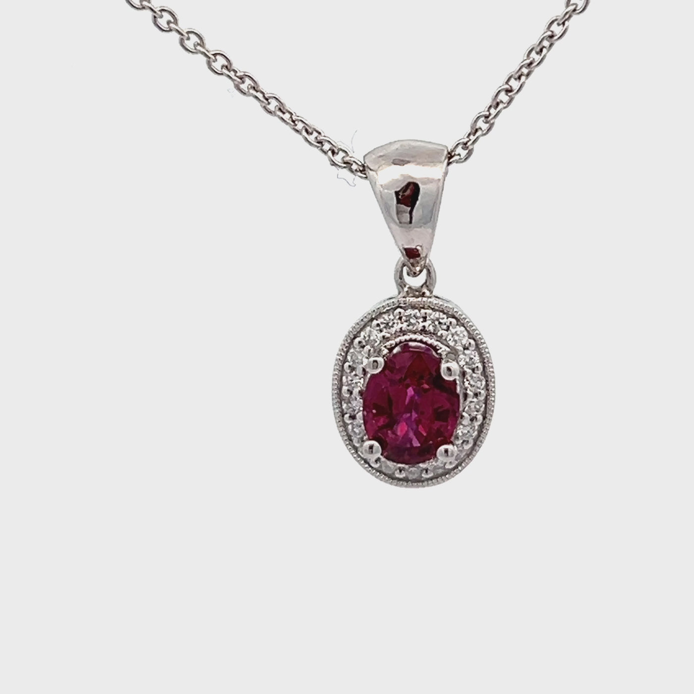 14k White Gold Oval Ruby and Round Diamond Prong Set Halo Pendant (0.82ct.)